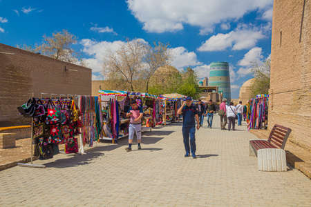 KHIVA, UZBEKISTAN - APRIL 25, 2018: Tourists walk at the Pahlavon Mahmud street in the old town of Khiva, Uzbekistanのeditorial素材