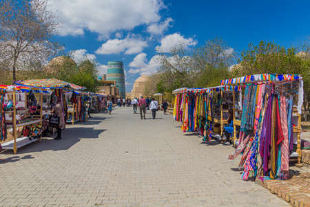 KHIVA, UZBEKISTAN - APRIL 25, 2018: Tourists walk at the Pahlavon Mahmud street in the old town of Khiva, Uzbekistanのeditorial素材