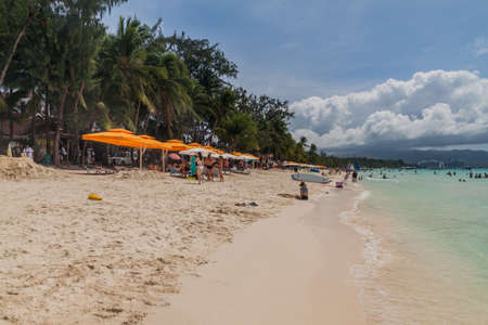 BORACAY, PHILIPPINES - FEBRUARY 1, 2018: Tourists enjoy the White Beach at Boracay island,...
