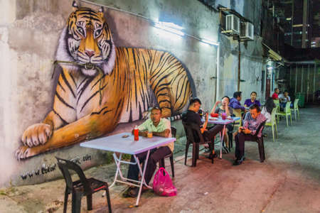 GEORGE TOWN, MALAYSIA - MARCH 20, 2018: Evening view of outdoor food stalls and a tiger in George Town, Malaysiaのeditorial素材