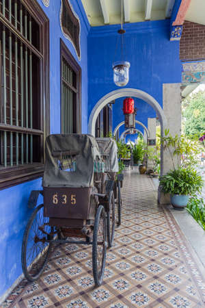 GEORGE TOWN, MALAYSIA - MARCH 20, 2018: Rickshaws at the Cheong Fatt Tze Mansion (The Blue Mansion) in George Town, Malaysiaのeditorial素材