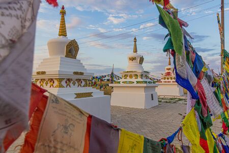 Stupas and flags near Syakusn Syume, Geden Sheddup Choikorling Monastery, Tibetan Buddhist monastery...