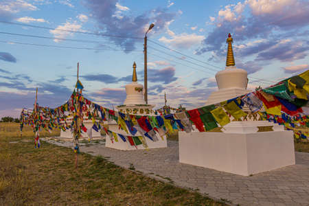 Stupas and flags near Syakusn Syume, Geden Sheddup Choikorling Monastery, Tibetan Buddhist monastery in Elista, Republic of Kalmykia, Russiaの写真素材