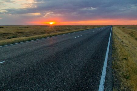Sunset view of a road in russian steppeの写真素材