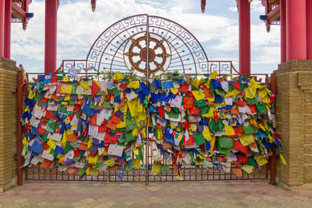 Buddhist flags at the gate of the Buddhist temple complex The Golden Abode of the Buddha Shakyamuni...