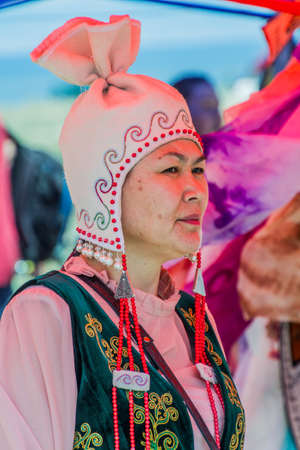 ISSYK KUL, KYRGYZSTAN - JULY 15, 2018: Local woman wearing traditional dress at the Ethnofestival Teskey Jeek at the coast of Issyk Kul lake in Kyrgyzstanのeditorial素材