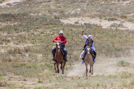 ISSYK KUL, KYRGYZSTAN - JULY 15, 2018: Performance of kyz kuuma (girl chasing), equestrian...