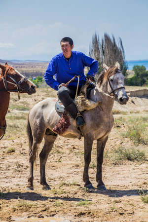 ISSYK KUL, KYRGYZSTAN - JULY 15, 2018: Player of kok boru, traditional horse game, with a goat...