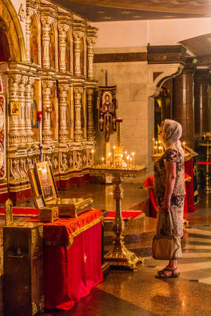 YEKATERINBURG, RUSSIA - JULY 3, 2018: Woman in the Church on Blood in Honour of All Saints Resplendent in the Russian Land in Yekaterinburg, Russiaのeditorial素材