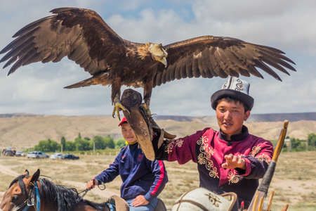 ISSYK KUL, KYRGYZSTAN - JULY 15, 2018: Local man with his eagle at the Ethnofestival Teskey Jeek at...