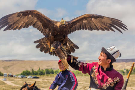ISSYK KUL, KYRGYZSTAN - JULY 15, 2018: Local man with his eagle at the Ethnofestival Teskey Jeek at...