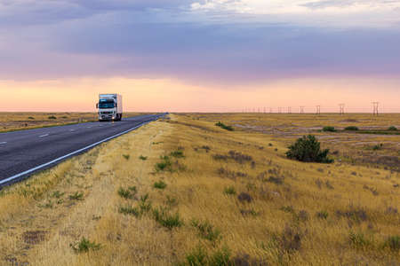 KALMYKIA, RUSSIA - JUNE 26, 2018: Truck on a road through Russian steppe in Kalmykia, Russia.のeditorial素材