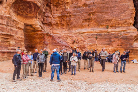 PETRA, JORDAN - MARCH 23, 2017: Group of tourists in the ancient city Petra, Jordanのeditorial素材