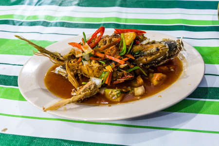 Fish dish at a seafood restaurant at the night market in Kota Kinabalu, Sabah, Malaysiaの写真素材