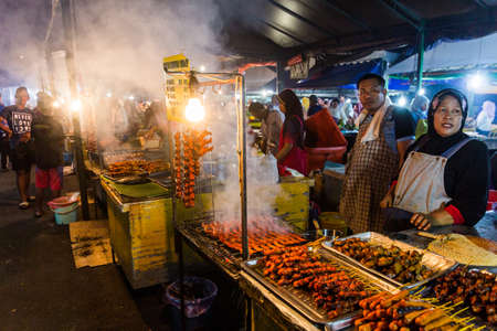 KOTA KINABALU, MALAYSIA - FEBRUARY 25, 2018: Chicken stalls at the night market in Kota Kinabalu, Sabah, Malaysia