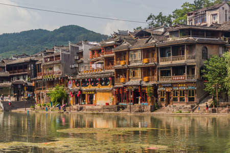 FENGHUANG, CHINA - AUGUST 14, 2018: Riverside houses in Fenghuang Ancient City, Hunan province, Chinaのeditorial素材