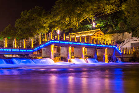 Night view of a bridge and weir in Fenghuang Ancient Town, Hunan province, Chinaのeditorial素材