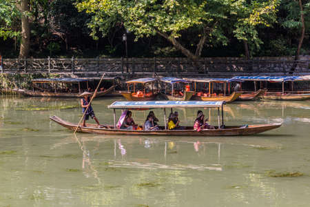 FENGHUANG, CHINA - AUGUST 14, 2018: Boats at Tuo river in Fenghuang Ancient City, Hunan province,...