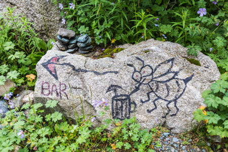 Sign bar on a rock near Ala Kul lake in Kyrgyzstanの写真素材