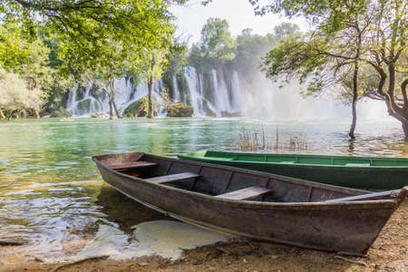 Boats at Kravica waterfalls in Bosnia and Herzegovinaの写真素材