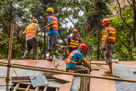 ZHANGJIAJIE, CHINA - AUGUST 9, 2018: Construction workers in Zhangjiajie National Forest Park in...