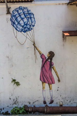 GEORGE TOWN, MALAYSIA - MARCH 20, 2018: Girl with bottles street art in George Town, Malaysiaのeditorial素材