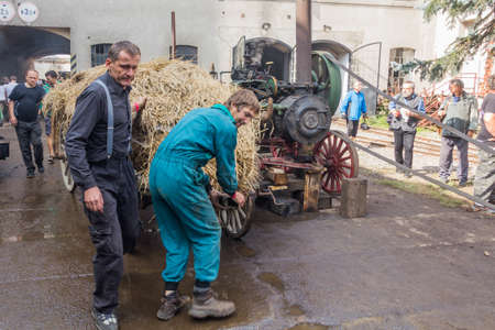 ZAMBERK, CZECHIA - SEPTEMBER 15, 2018: Old portable steam engine and a wagon in the Old Machines and Technologies Museum (Muzeum starych stroju a technologii) in Zamberk, Czechia.のeditorial素材