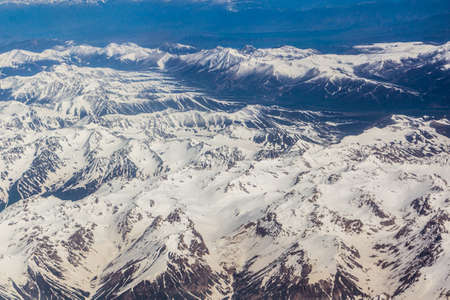 Aerial view of snow covered Tian Shan mountains in Kyrgyzstanの写真素材