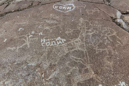 WAKHAN VALLEY, TAJIKISTAN - MAY 23, 2018: Ancient petroglyphs and modern grafitti in Langar village in Wakhan valley, Tajikistanのeditorial素材