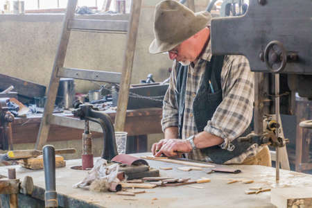 ZAMBERK, CZECHIA - SEPTEMBER 15, 2018: Man working in a 19th century workshop in the Old Machines and Technologies Museum (Muzeum starych stroju a technologii) in Zamberk, Czechia.のeditorial素材