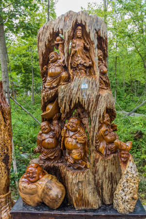 WULINGYUAN, CHINA - AUGUST 9, 2018: Carved wood souvenirs for sale in Wulingyuan Scenic and Historic Interest Area in Zhangjiajie National Forest Park in Hunan province, Chinaのeditorial素材