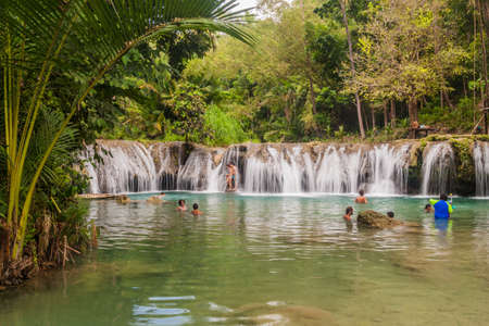 SIQUIJOR, PHILIPPINES - FEBRUARY 9, 2018: People enjoy Cambugahay Falls on Siquijor island, Philippines.のeditorial素材