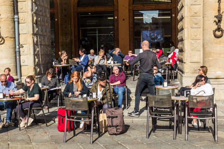 BOLOGNA, ITALY - OCTOBER 22, 2018: People enjoy a cafe in Bologna, Italyのeditorial素材