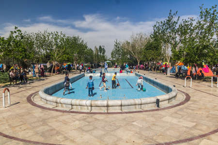TEHRAN, IRAN - APRIL 2, 2018: People are camping and children playing in the park around Mausoleum...