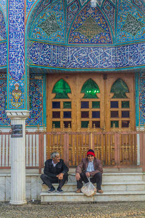 LAHIJAN, IRAN - APRIL 8, 2018: Local men sit in front of Chahar Padshahan (Padeshah) mosque in...