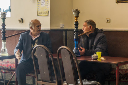 ARDABIL, IRAN - APRIL 11, 2018: Local men with waterpipes in a tea house in Ardabil, Iran