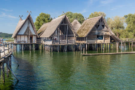 UNTERUHLDINGEN, GERMANY - SEPTMBER 3, 2019:  Stilt houses (Pfahlbauten), Stone and Bronze age dwellings in Unteruhldingen town, Baden-Wurttemberg state, Germanyのeditorial素材