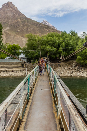 KHOROG, TAJIKISTAN - MAY 21, 2018: Hanging bridge over Gunt river in Khorog town, Tajikistanのeditorial素材