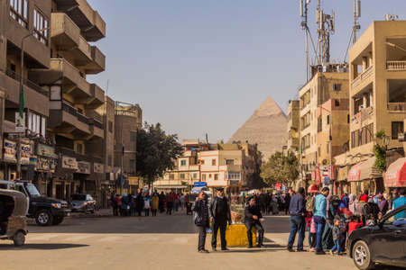 CAIRO, EGYPT - JANUARY 31, 2019: View of the Pyramid of Khafre and a busy street in Giza neighborhood of Cairo, Egyptのeditorial素材