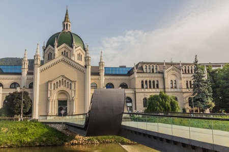 SARAJEVO, BOSNIA AND HERZEGOVINA - JUNE 12, 2019: The Academy of Fine Arts and Festina lente pedestrian bridge over the Miljacka River in Sarajevo, Bosnia and Herzegovinaのeditorial素材