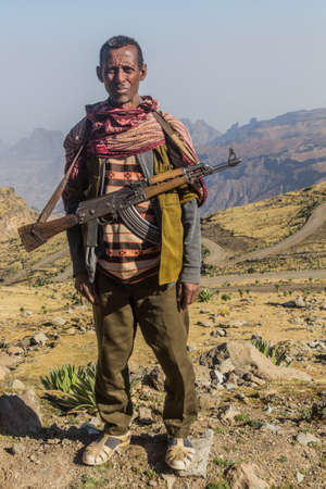 SIMIEN MOUNTAINS, ETHIOPIA - MARCH 17, 2019: Armed scout guarding tourists in Simien mountains, Ethiopiaのeditorial素材