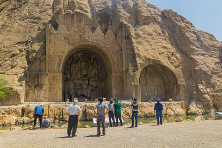 KERMANSHAH, IRAN - JULY 11, 2019: People observe reliefs at Taq-e Bostan in Kermanshah, Iranのeditorial素材