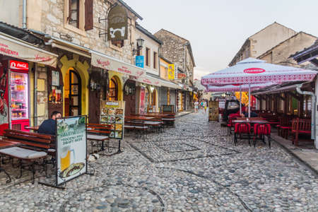 MOSTAR, BOSNIA AND HERZEGOVINA - JUNE 10, 2019: Old street with open air restaurants in Mostar. Bosnia and Herzegovinaのeditorial素材