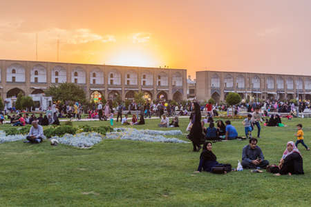 ISFAHAN, IRAN - JULY 10, 2019: People enjoying evening at Naqsh-e Jahan Square in Isfahan, Iran