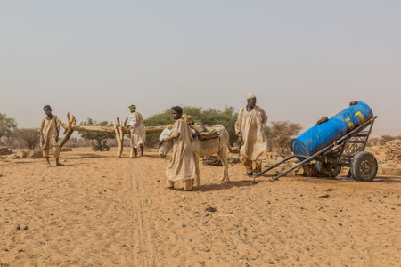 RIVER NILE STATE, SUDAN - MARCH 5, 2019: Villagers at a well in a dry region of Sudan.のeditorial素材