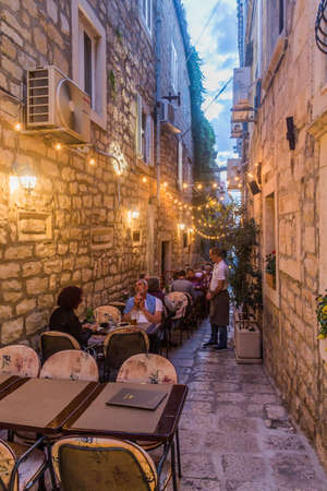 KORCULA, CROATIA - MAY 29, 2019: Alley with open air restaurant in Korcula town, Croatiaのeditorial素材