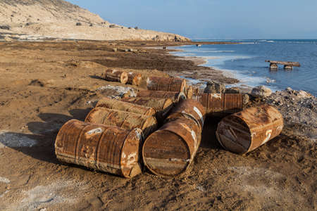 Old rusty barrels around saline lake Assal in Djiboutiの写真素材
