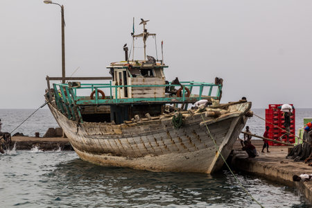 TADJOURA, DJIBOUTI - APRIL 20, 2019: Wooden cargo boat in the port of Tadjoura, Djibouti