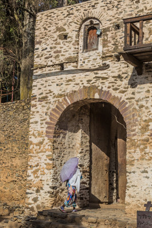 Woman at the entrance gate of Debre Birhan (Berhan) Selassie church in Gondar, Ethiopia.