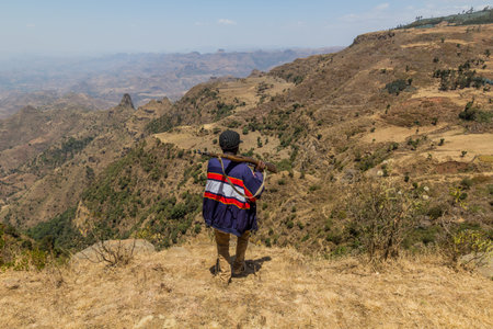KOSOYE, ETHIOPIA - MARCH 14, 2019: Armed scout escort in the mountains near Kosoye village, Ethiopia